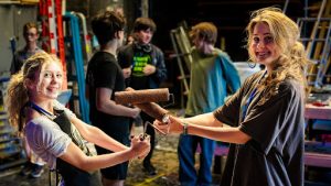 Salome Casey (left) and Gwen Kjallbring (right) prepare to paint the set.