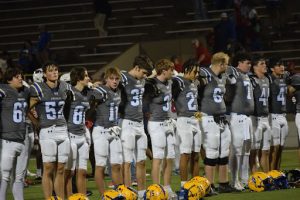 Trojan Football Team stands together after the game to celebrate their memorable victory against Hays.